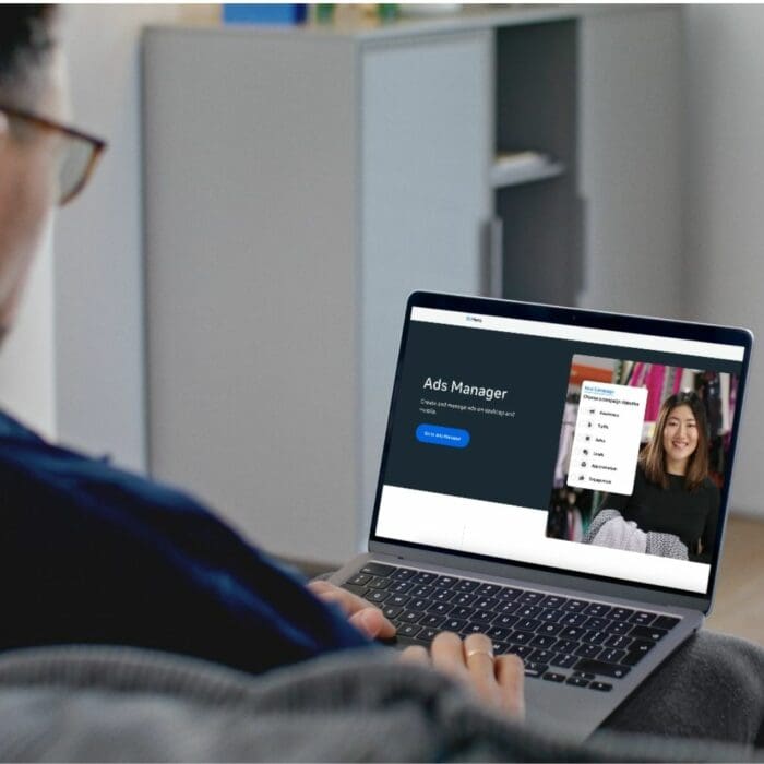 a man using his laptop to look at meta ads manager